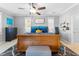 Bright main bedroom with ceiling fan, picture window, and a decorative area rug at 3406 Regner Dr, Plant City, FL 33566