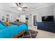 Spacious main bedroom with a ceiling fan, a view of the backyard and a dark wood dresser at 3406 Regner Dr, Plant City, FL 33566