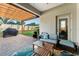 Covered patio featuring a wooden pergola, comfortable seating, and an outdoor grill for relaxing gatherings at 3406 Regner Dr, Plant City, FL 33566