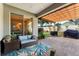 Inviting covered patio with comfortable seating, an outdoor rug, and a view of the lush backyard at 3406 Regner Dr, Plant City, FL 33566