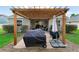 Backyard featuring a pergola-covered patio with a barbecue grill, creating an ideal outdoor cooking space at 3406 Regner Dr, Plant City, FL 33566