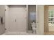 Elegant bathroom with a glass-enclosed shower, neutral tile, and modern fixtures, providing a spa-like experience at 3475 Silent Gardens Cv, Wesley Chapel, FL 33543