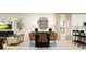 Open-concept dining room featuring modern furniture, stylish lighting, and seamless living spaces at 3475 Silent Gardens Cv, Wesley Chapel, FL 33543