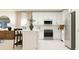 Modern kitchen with white cabinets, stainless steel appliances, and a center island with breakfast bar seating at 3475 Silent Gardens Cv, Wesley Chapel, FL 33543