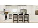 Modern kitchen with stainless steel appliances and bar seating at 3475 Silent Gardens Cv, Wesley Chapel, FL 33543