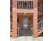Building entrance featuring stairs, a doorway, and an upstairs balcony in an older building complex at 3514 Gulf # 2, St Petersburg, FL 33706