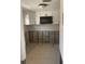 A kitchen with white cabinets, a microwave, and unfinished walls ready for renovation at 3514 Gulf # 2, St Petersburg, FL 33706