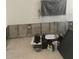 Living room ready for renovation with exposed concrete walls, tile floor, and a TV covered in plastic at 3514 Gulf # 2, St Petersburg, FL 33706