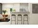 Stylish kitchen with bar seating, stainless steel appliances, and open layout, perfect for socializing at 36089 Risa Michele St, Zephyrhills, FL 33541