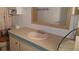 This bathroom features a built in sink with white cabinetry and a framed mirror at 37648 Campo Ave, Zephyrhills, FL 33541