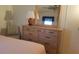 Bright bedroom with a large dresser, mirror, and a comfortable chair at 37648 Campo Ave, Zephyrhills, FL 33541
