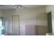 This bedroom features wallpaper, a ceiling fan, and built in storage at 37648 Campo Ave, Zephyrhills, FL 33541