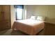 Cozy bedroom featuring comfortable bedding and natural light from the window at 37648 Campo Ave, Zephyrhills, FL 33541