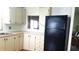 Functional kitchen featuring cabinets and an updated black refrigerator at 37648 Campo Ave, Zephyrhills, FL 33541