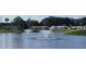 Scenic lake view with water fountains and surrounding community homes, offering a peaceful atmosphere at 37648 Campo Ave, Zephyrhills, FL 33541
