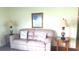 Cozy living room setup with a plush sofa and decorative lamps at 37648 Campo Ave, Zephyrhills, FL 33541