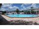 Inviting community pool with ample seating and shaded areas, perfect for relaxation and recreation at 37648 Campo Ave, Zephyrhills, FL 33541