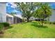 Expansive backyard with screened lanais and mature trees offering privacy and space for outdoor enjoyment at 4006 Cypress Lane #4006 # 4006, Tampa, FL 33618