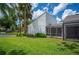 Well-maintained home featuring a screened lanai, lush lawn and manicured landscaping at 4006 Cypress Lane #4006 # 4006, Tampa, FL 33618