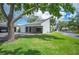 Attached carport offering convenience and covered parking surrounded by lush landscaping and mature trees at 4006 Cypress Lane #4006 # 4006, Tampa, FL 33618