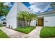 Charming home featuring a clean, modern design, complemented by lush greenery and vibrant palm trees at 4006 Cypress Lane #4006 # 4006, Tampa, FL 33618
