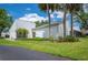 Well-maintained home featuring a lush lawn, manicured landscaping, and mature trees at 4006 Cypress Lane #4006 # 4006, Tampa, FL 33618
