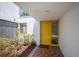 Welcoming entryway features a bright yellow door with brick accents, creating a warm first impression at 4006 Cypress Lane #4006 # 4006, Tampa, FL 33618