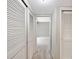 Hallway with multiple closets leading to a carpeted room, maximizing storage space at 4006 Cypress Lane #4006 # 4006, Tampa, FL 33618