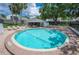 Inviting community pool surrounded by brick, lounge chairs, and lush landscaping offers a relaxing oasis at 4006 Cypress Lane #4006 # 4006, Tampa, FL 33618