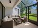 Relaxing screened patio features wicker furniture and views of the manicured lawn at 4006 Cypress Lane #4006 # 4006, Tampa, FL 33618