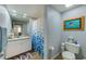 Bathroom featuring a vanity with a large mirror and a shower with a blue-patterned curtain at 402 S Armenia Ave # 139A, Tampa, FL 33609