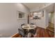 Dining area with hardwood floors, a four-chair round table, and a view of the kitchen at 402 S Armenia Ave # 139A, Tampa, FL 33609