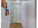 Hallway leading to a white front door with two paintings hanging on the light blue wall at 402 S Armenia Ave # 139A, Tampa, FL 33609