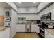 Bright kitchen area with white cabinets and stainless steel appliances at 402 S Armenia Ave # 139A, Tampa, FL 33609