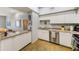 A kitchen area featuring white cabinetry and stainless steel appliances, with an open view at 402 S Armenia Ave # 139A, Tampa, FL 33609