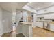 Bright kitchen featuring white cabinetry, stainless steel appliances, and a view of the living area at 402 S Armenia Ave # 139A, Tampa, FL 33609