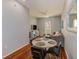 Living area featuring hardwood floors, a four-chair round table, and a comfortable seating arrangement at 402 S Armenia Ave # 139A, Tampa, FL 33609