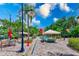 Community pool area with tables, umbrellas, seating, and lush landscaping at 402 S Armenia Ave # 139A, Tampa, FL 33609