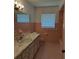 Bathroom featuring tile walls and floors, a single sink vanity, and a window with natural light at 406 Bullard Pkwy, Temple Terrace, FL 33617