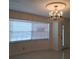 Inviting entryway with tile floor and elegant chandelier with window at 406 Bullard Pkwy, Temple Terrace, FL 33617