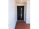 Modern black front door with a glass insert in a white brick facade with a red tile entry at 406 Bullard Pkwy, Temple Terrace, FL 33617