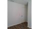 Hallway featuring wood-look laminate flooring and a white door at 406 Bullard Pkwy, Temple Terrace, FL 33617