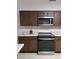 Functional kitchen featuring stainless steel appliances and ample countertop space at 406 Bullard Pkwy, Temple Terrace, FL 33617