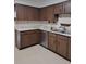 Kitchen with wood cabinets, white countertops, and stainless steel appliances at 406 Bullard Pkwy, Temple Terrace, FL 33617