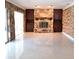 Living room featuring a stone fireplace, built-in cabinets, and a large window with natural light at 406 Bullard Pkwy, Temple Terrace, FL 33617