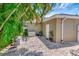 Backyard view with brick pavers, landscaping and a home generator at 4125 W Obispo St, Tampa, FL 33629
