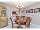 Elegant dining room with a wooden table, stylish chairs, decorative artwork, and a china cabinet at 4125 W Obispo St, Tampa, FL 33629