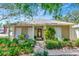 Charming single-story home with a well-maintained front yard, inviting entrance, and a cozy seating area on the porch at 4125 W Obispo St, Tampa, FL 33629