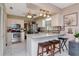 Bright kitchen featuring white cabinets, stainless steel appliances, granite countertops, and a breakfast bar at 4125 W Obispo St, Tampa, FL 33629