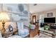 Cozy living room featuring hardwood floors, large windows, a comfortable chair, and stylish decor, creating a warm atmosphere at 4125 W Obispo St, Tampa, FL 33629